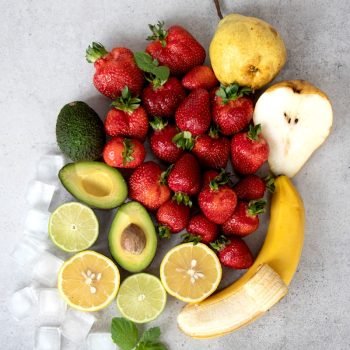 strawberries and bananas on white table